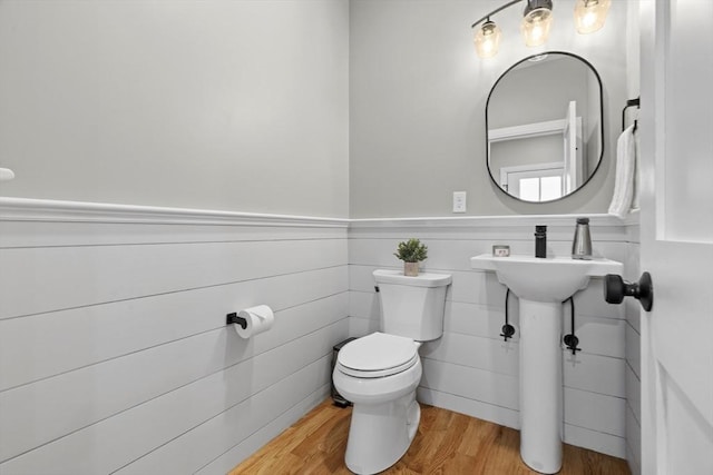 33 Peirce St Unit 1, Waltham, MA 02453 - bathroom with toilet, a wainscoted wall, and wood finished floors