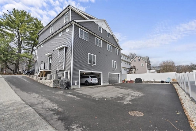 33 Peirce St Unit 1, Waltham, MA 02453 - view of home's exterior with a garage, aphalt driveway, a residential view, and fence