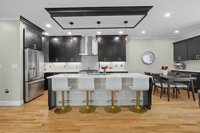 33 Peirce St Unit 1, Waltham, MA 02453 - kitchen with light countertops, wall chimney exhaust hood, dark cabinetry, a sink, and high quality fridge