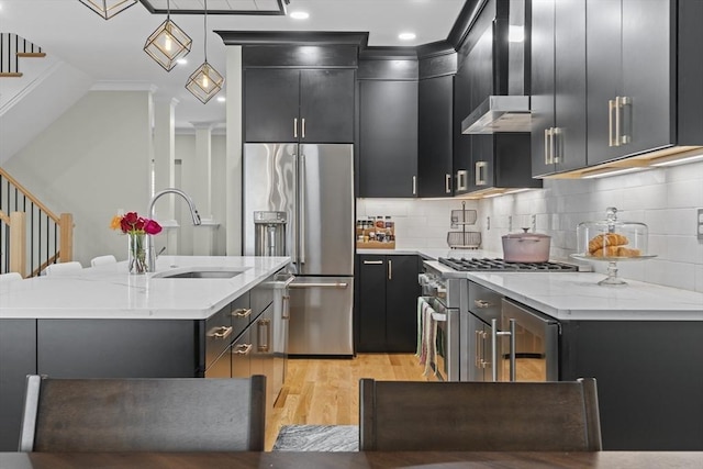 33 Peirce St Unit 1, Waltham, MA 02453 - kitchen with premium appliances, light wood-style floors, a sink, and dark cabinetry