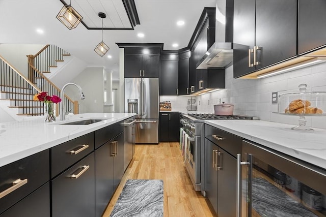33 Peirce St Unit 1, Waltham, MA 02453 - kitchen with high end appliances, wall chimney exhaust hood, dark cabinetry, beverage cooler, and a sink