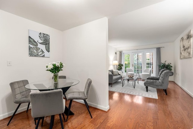 dining area with wood finished floors and baseboards
