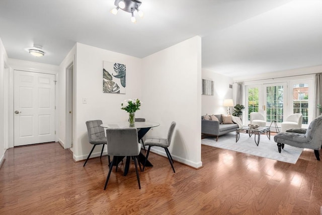 dining space with wood finished floors and baseboards