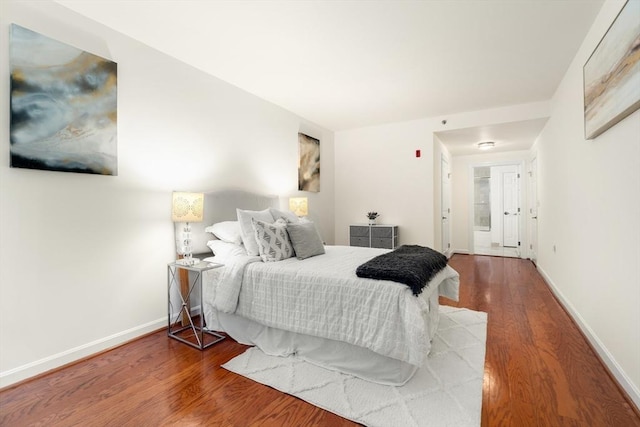 bedroom with wood finished floors and baseboards