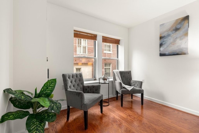 sitting room with wood finished floors and baseboards