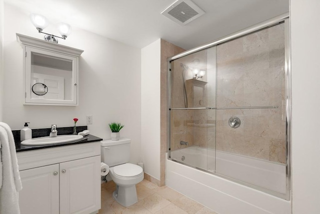 bathroom with vanity, toilet, enclosed tub / shower combo, tile patterned flooring, and baseboards