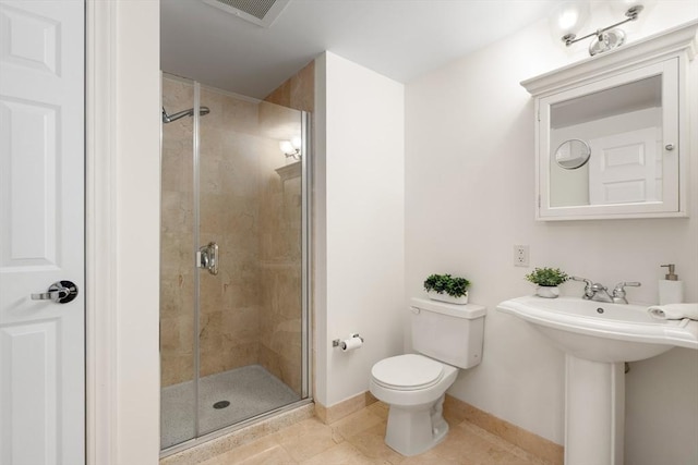 full bath with a shower stall, toilet, tile patterned flooring, baseboards, and a sink