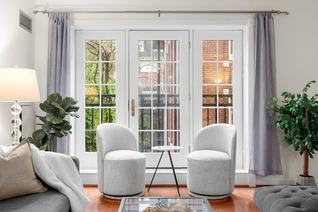 doorway to outside featuring plenty of natural light and wood finished floors