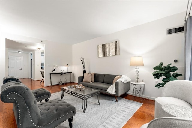living area featuring baseboards and wood finished floors