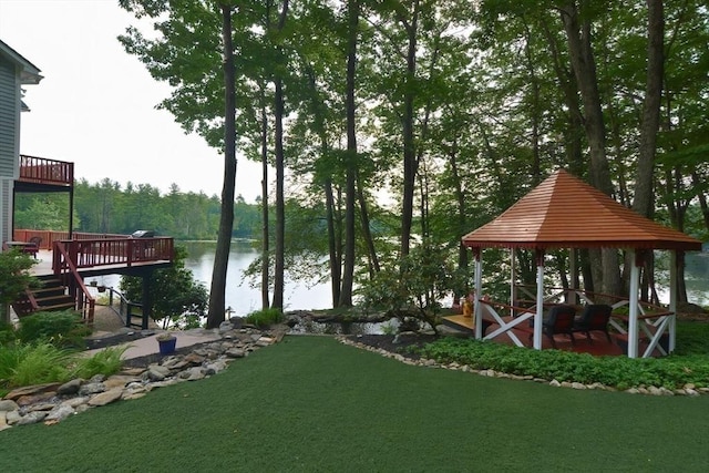 exterior space featuring a gazebo, a yard, and a water view