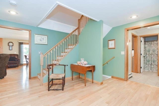 interior space featuring wood-type flooring and baseboard heating