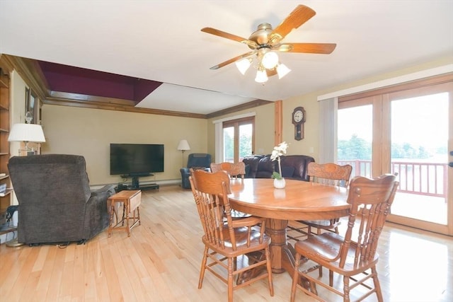 dining space featuring ceiling fan, light hardwood / wood-style flooring, and crown molding