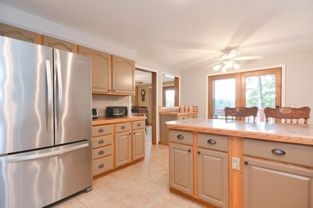 kitchen featuring stainless steel fridge, ceiling fan, and light tile patterned flooring