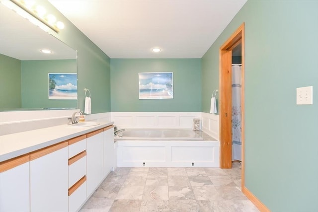 bathroom featuring a tub to relax in and vanity