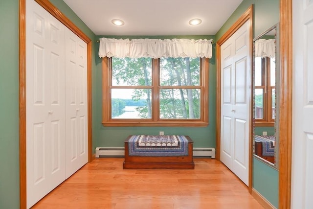 entryway with baseboard heating and light wood-type flooring