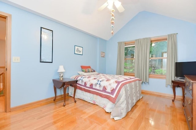 bedroom featuring light hardwood / wood-style floors, vaulted ceiling, and ceiling fan