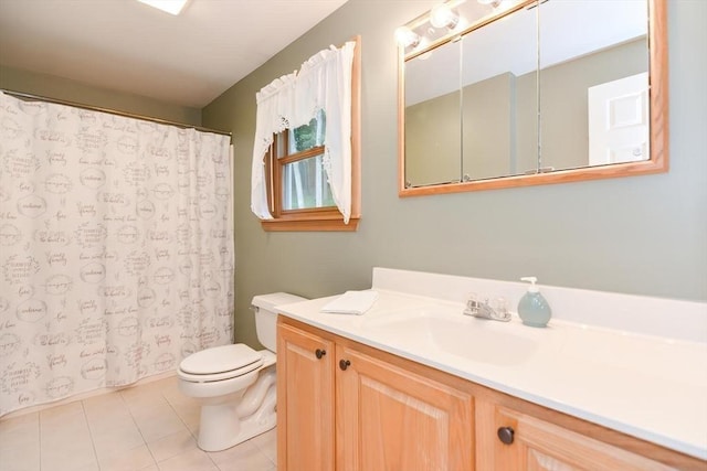 bathroom with tile patterned flooring, vanity, and toilet