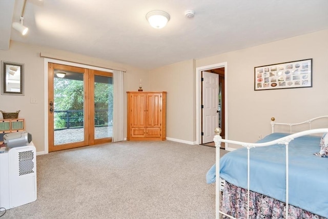 bedroom featuring access to outside and light colored carpet