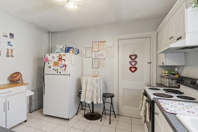 136-138 N St, Somerville, MA 02144 - kitchen featuring freestanding refrigerator, radiator, range with electric cooktop, and white cabinetry