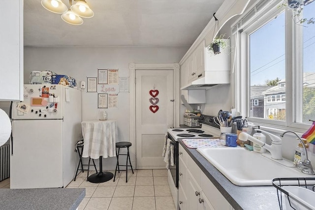 136-138 N St, Somerville, MA 02144 - kitchen featuring freestanding refrigerator, a sink, white cabinetry, electric stove, and light tile patterned floors