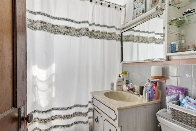 136-138 N St, Somerville, MA 02144 - bathroom with toilet, decorative backsplash, a shower with shower curtain, and vanity