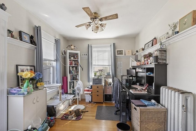 136-138 N St, Somerville, MA 02144 - office space with wood finished floors, ceiling fan, radiator heating unit, and a wealth of natural light