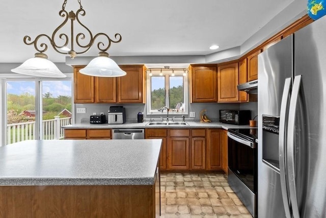 230 Plain, Taunton, MA 02780 - kitchen featuring stainless steel appliances, a sink, under cabinet range hood, brown cabinetry, and stone finish flooring