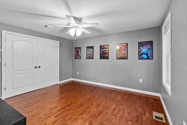 230 Plain, Taunton, MA 02780 - unfurnished bedroom with wood finished floors, baseboards, a closet, and a ceiling fan