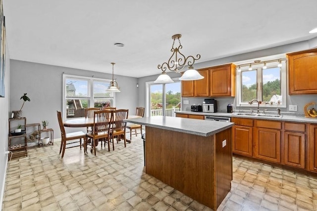 230 Plain, Taunton, MA 02780 - kitchen featuring a sink, a kitchen island, and brown cabinetry