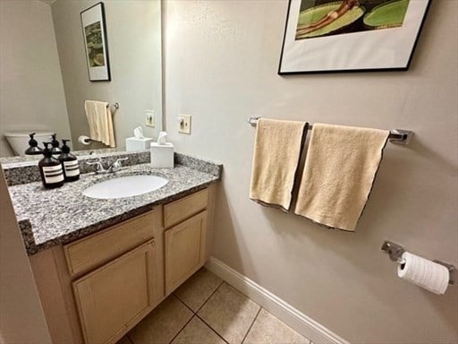 bathroom featuring toilet, vanity, and tile patterned floors