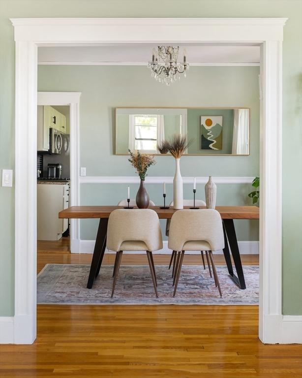 67 Jamaica Unit 3, Boston, MA 02130 - dining room featuring a chandelier, wood finished floors, ornamental molding, an office area, and baseboards
