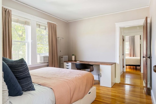 67 Jamaica Unit 3, Boston, MA 02130 - bedroom featuring radiator, light wood-style flooring, crown molding, and cooling unit