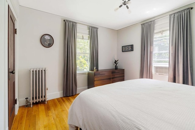 67 Jamaica Unit 3, Boston, MA 02130 - bedroom featuring radiator heating unit, multiple windows, light wood finished floors, and baseboards