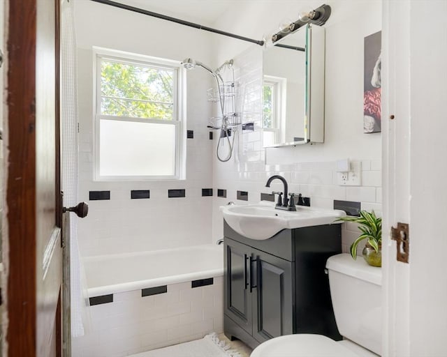 67 Jamaica Unit 3, Boston, MA 02130 - full bathroom with toilet, tile walls, vanity, and tiled shower / bath combo