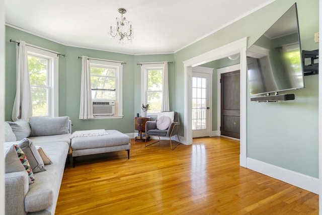 67 Jamaica Unit 3, Boston, MA 02130 - living area with light wood finished floors, crown molding, a chandelier, baseboards, and cooling unit