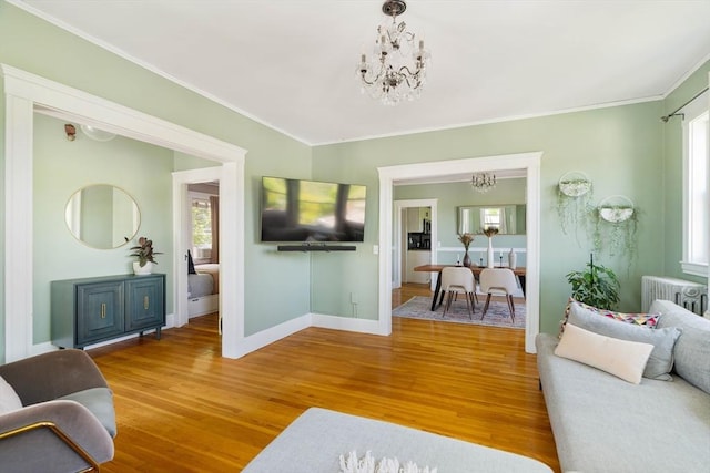 67 Jamaica Unit 3, Boston, MA 02130 - living area featuring a chandelier, radiator, wood finished floors, baseboards, and ornamental molding