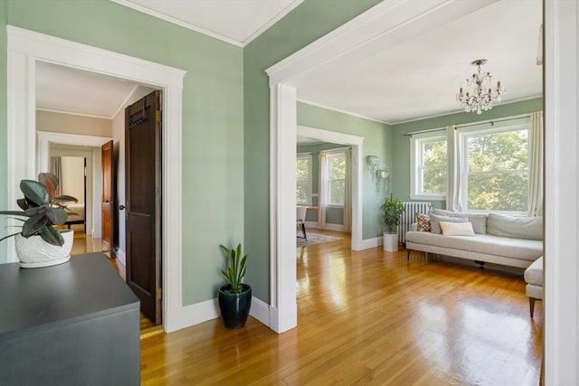 67 Jamaica Unit 3, Boston, MA 02130 - living area with a chandelier, light wood-type flooring, baseboards, and ornamental molding