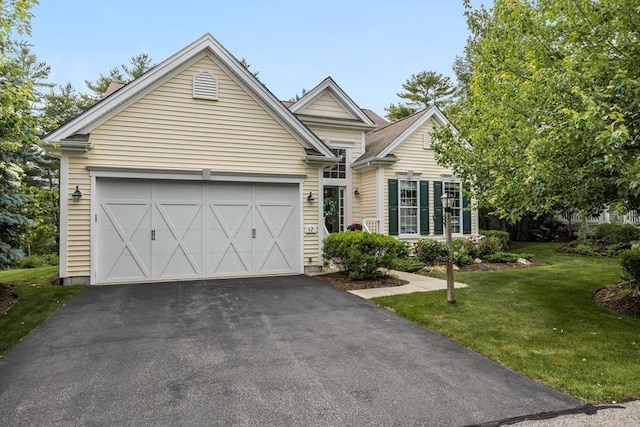 view of front of home with a garage and a front lawn