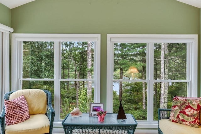 sunroom / solarium featuring lofted ceiling and a wealth of natural light