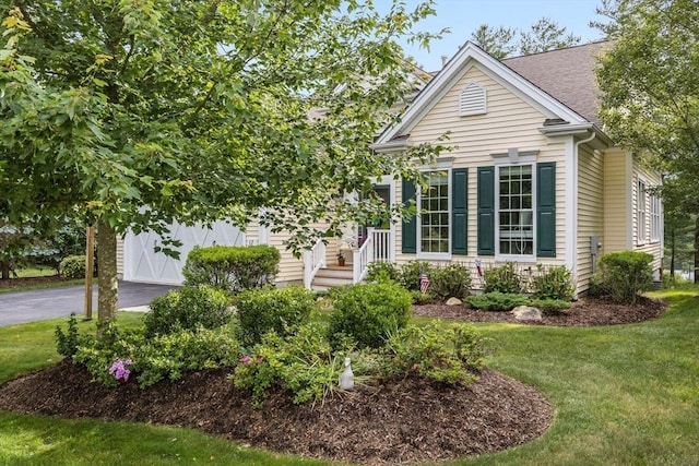 view of front of home featuring a garage and a front lawn