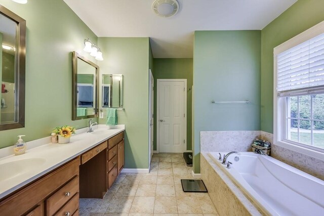 bathroom featuring vanity, tiled bath, and tile patterned floors