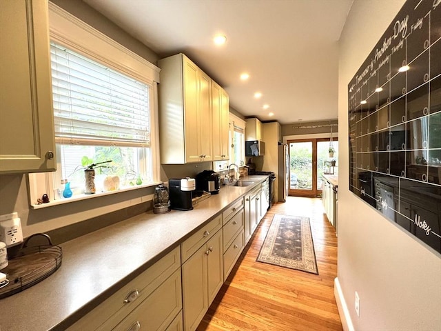 kitchen featuring recessed lighting, light wood-style floors, appliances with stainless steel finishes, and a sink