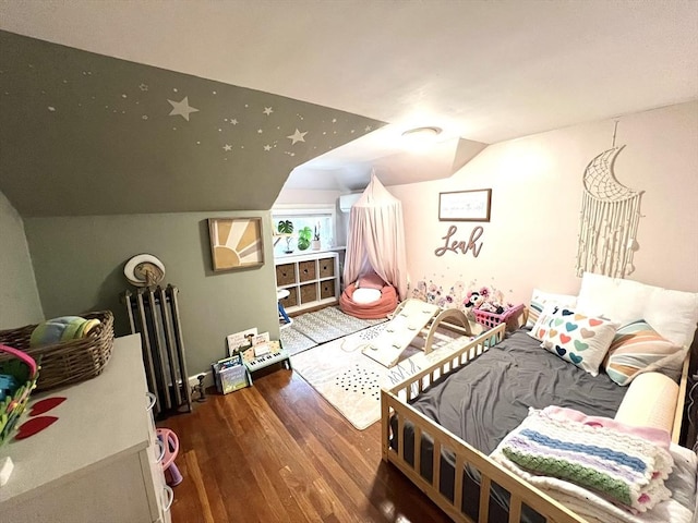 bedroom featuring lofted ceiling and wood finished floors