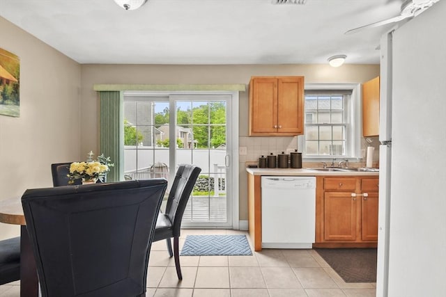 5239 N Main St Unit 7, Fall River, MA 02720 - kitchen featuring white appliances, a sink, light countertops, light tile patterned floors, and decorative backsplash