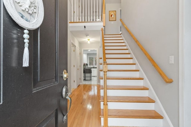 foyer featuring stairway and light wood-type flooring