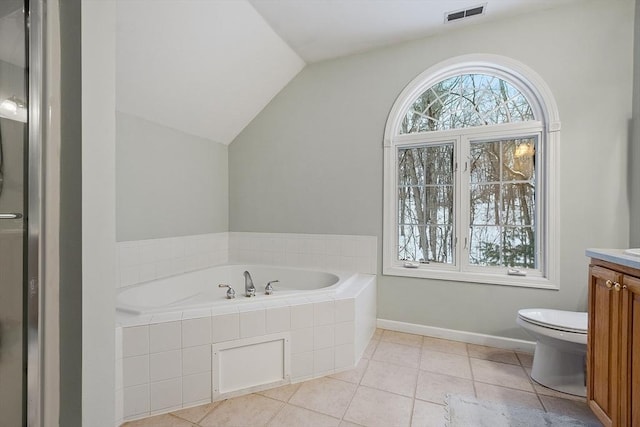 full bathroom with visible vents, a garden tub, toilet, vanity, and vaulted ceiling