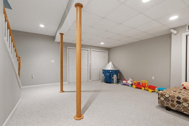 game room featuring carpet flooring, a paneled ceiling, and baseboards