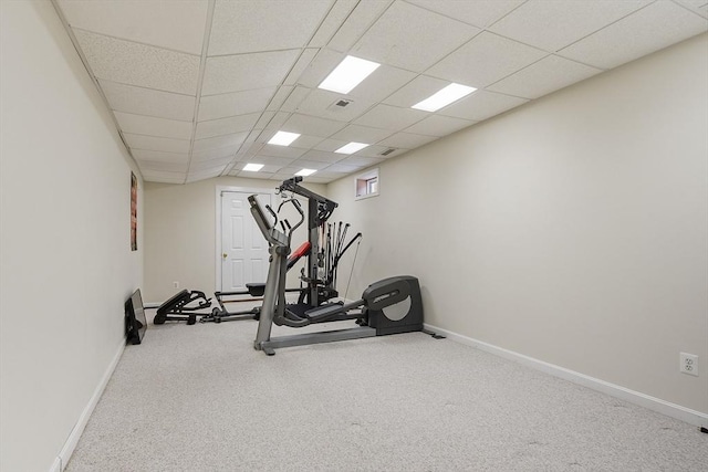 exercise room featuring visible vents, a paneled ceiling, baseboards, and carpet floors