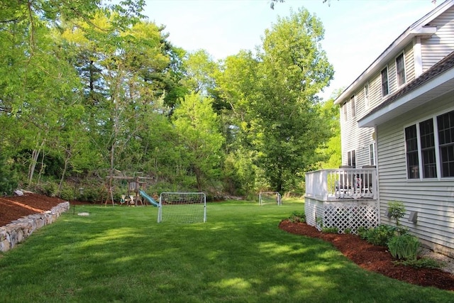 view of yard with a playground and a wooden deck