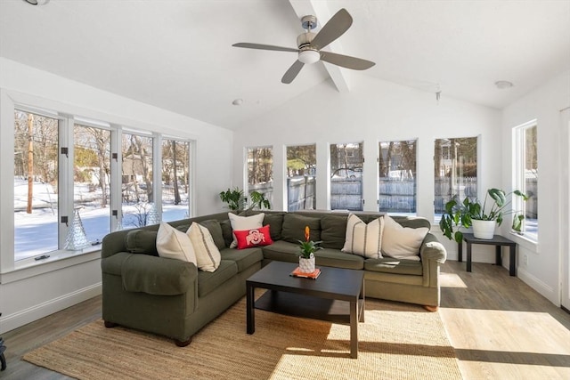 sunroom / solarium with lofted ceiling with beams and a ceiling fan